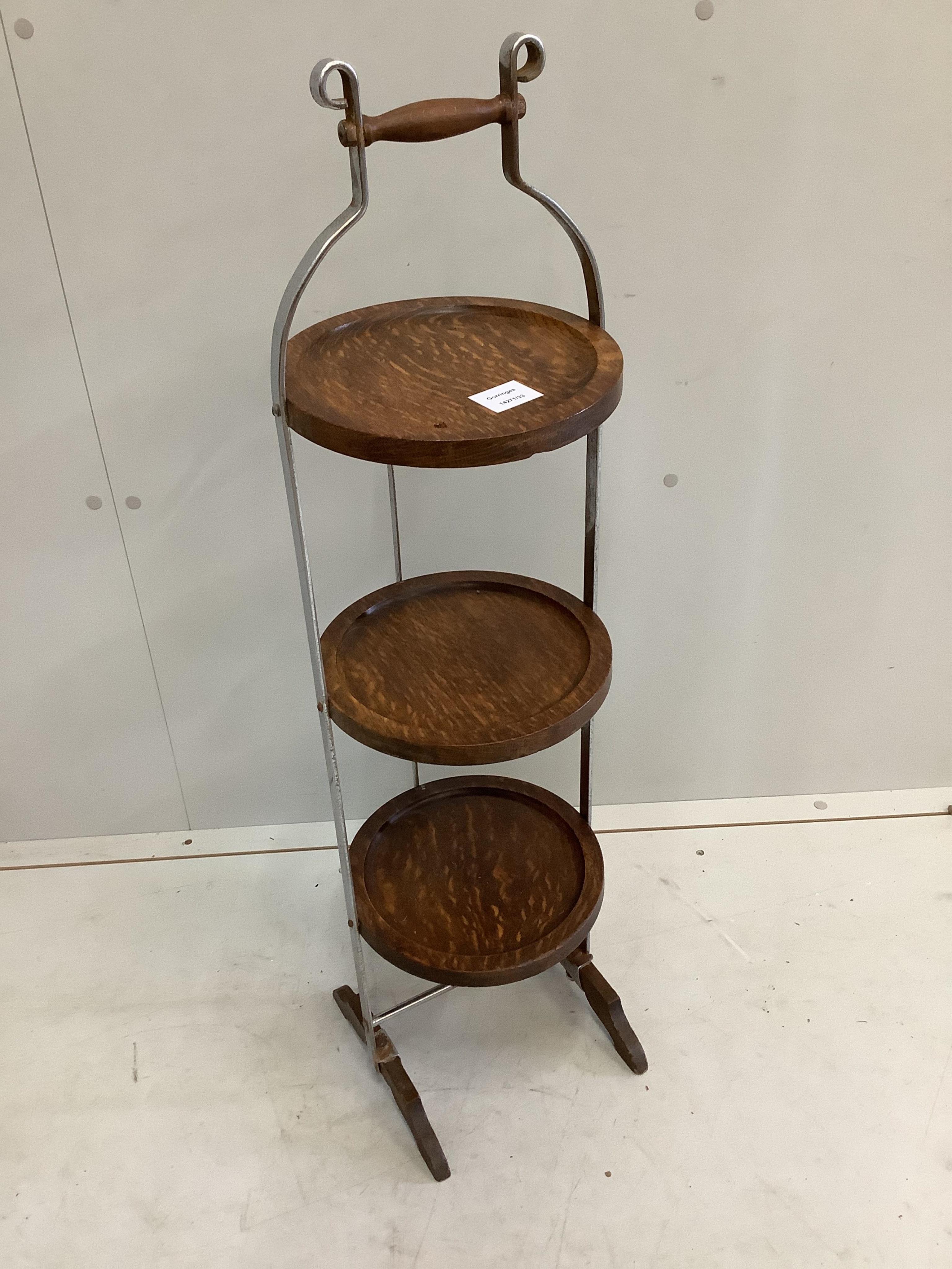 An oak and steel folding cake stand, height 92cm